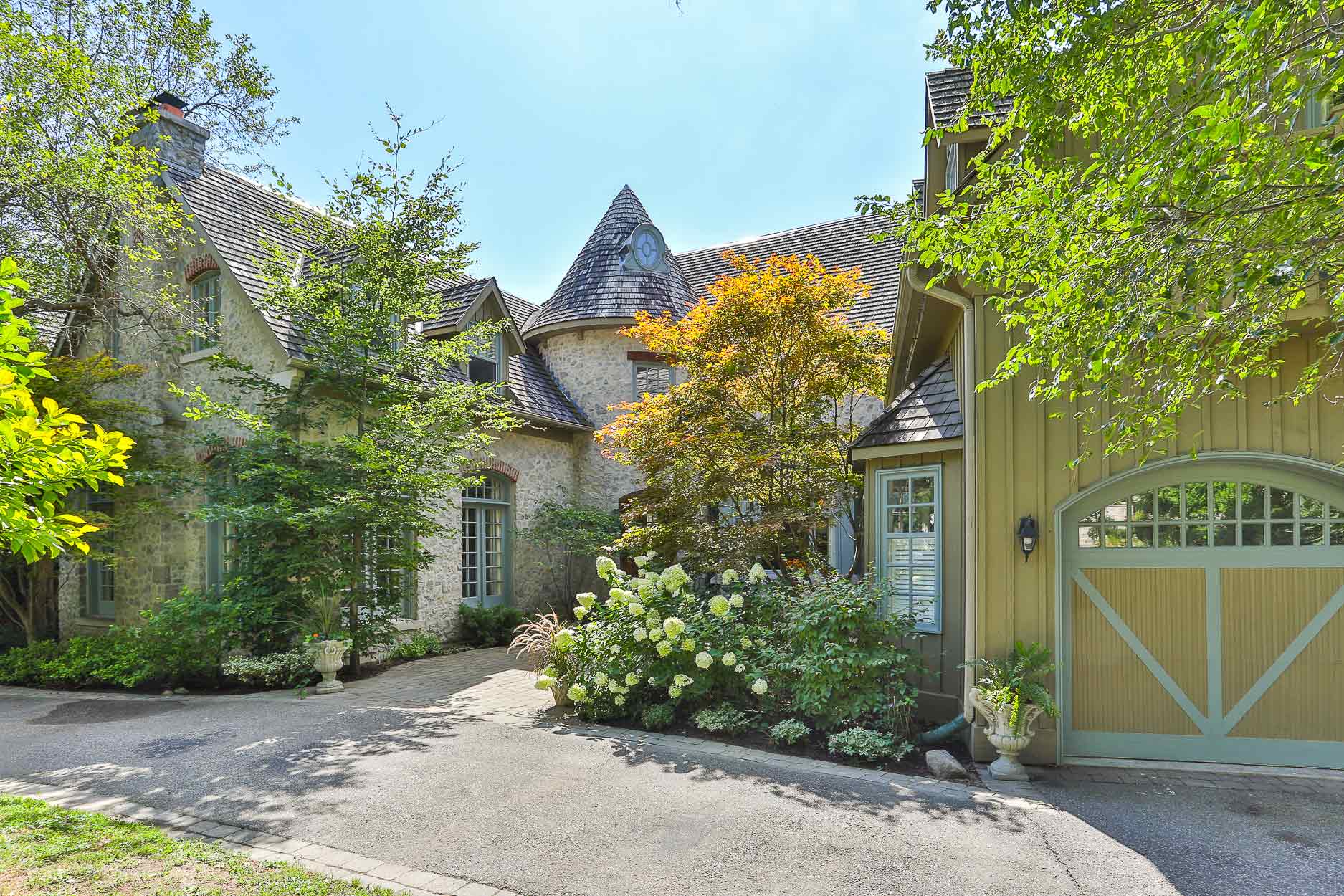 Charming stone cottage with turret and lush gardens
